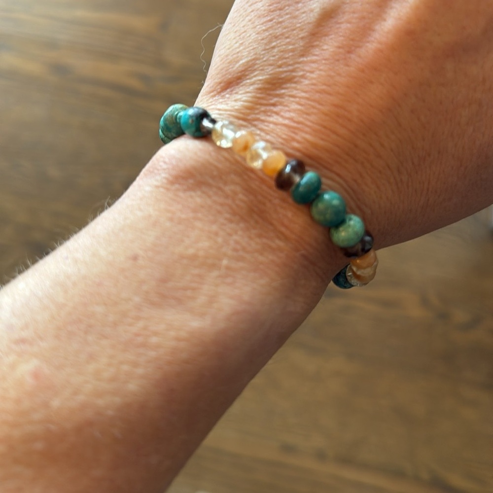 Turquoise and Citrine colored beaded bracelet with silver clasp.